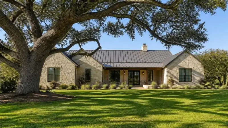 A limestone Hill Country home with a live oak in the front yard (illustrative photo)